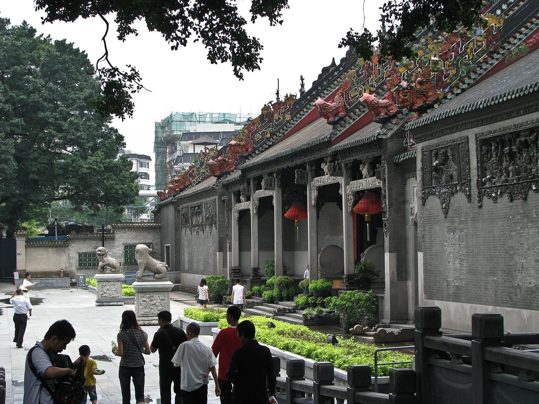 Oblique view of the hall’s front facade with decorated roof ridges.
