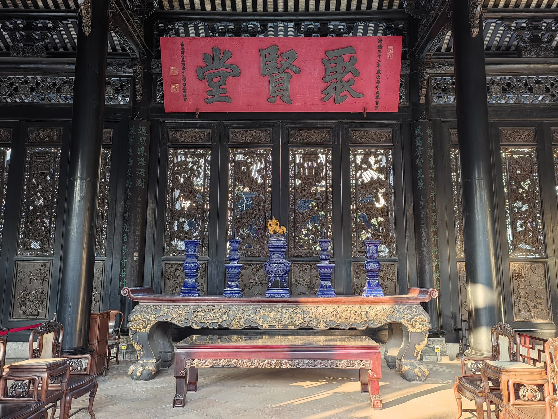 Juxian Hall plaque above a table and decorative objects in a later photograph.