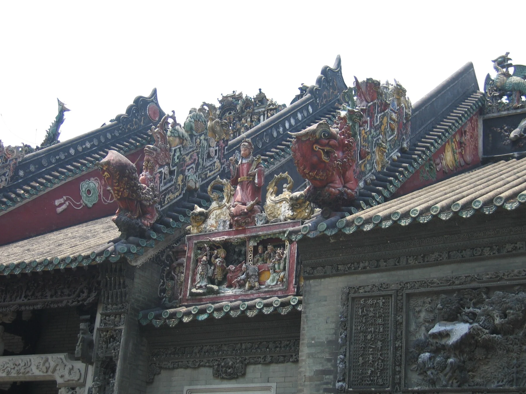 Decorated ridge and tiled roofs above the museum courtyard.