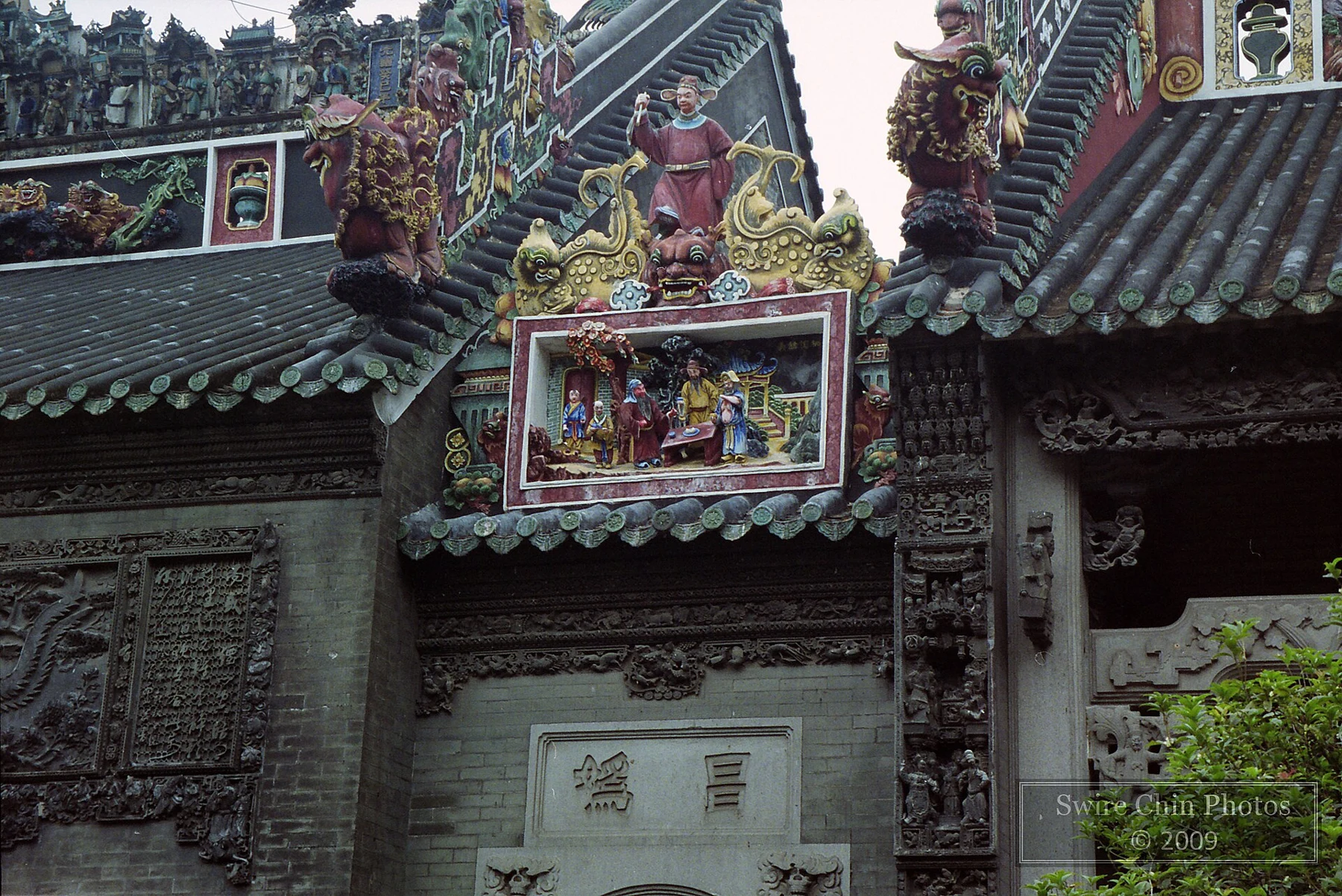 Colourful modelled figures and narrative decoration over a doorway.