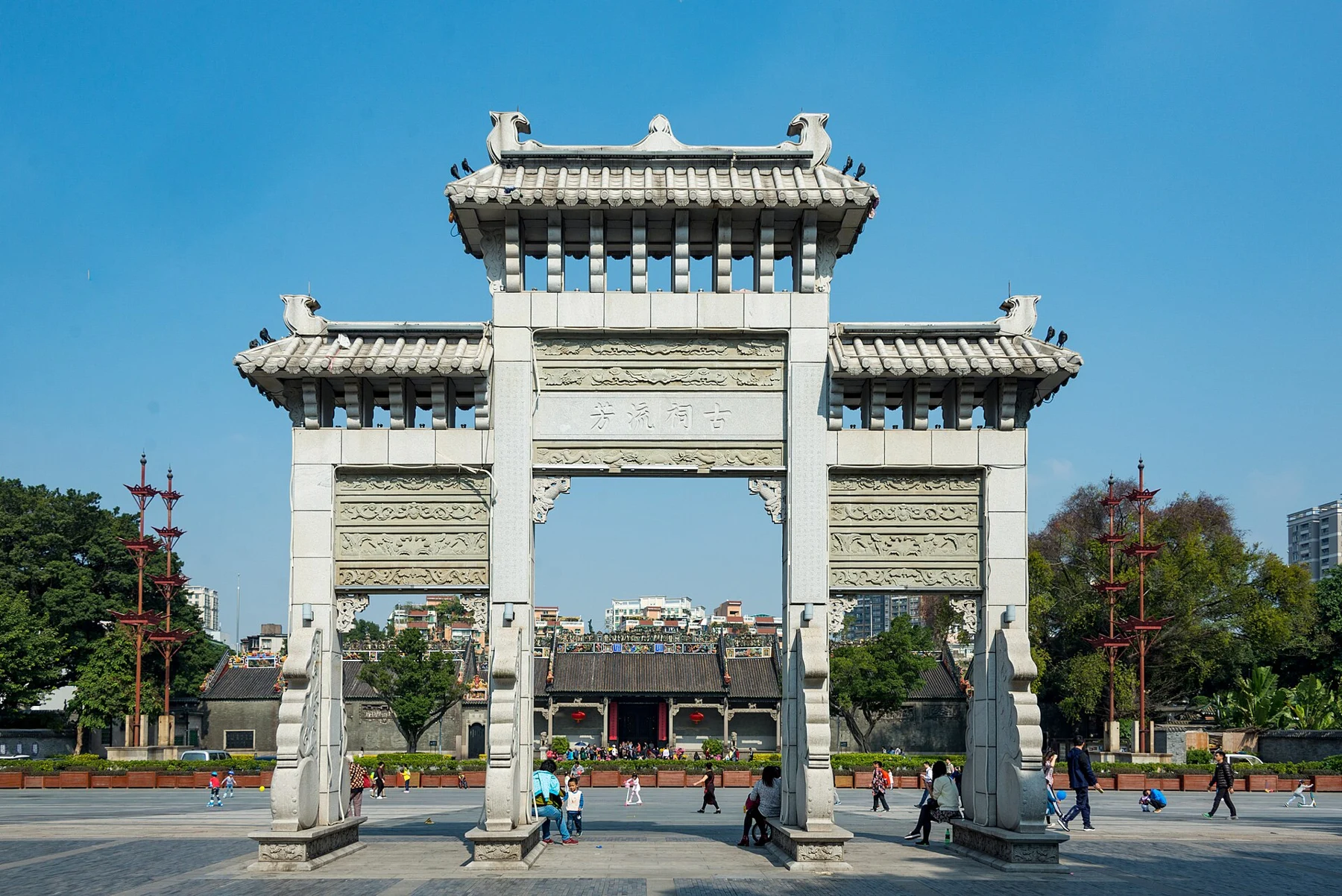 Stone archway framing the distant main hall across a forecourt.