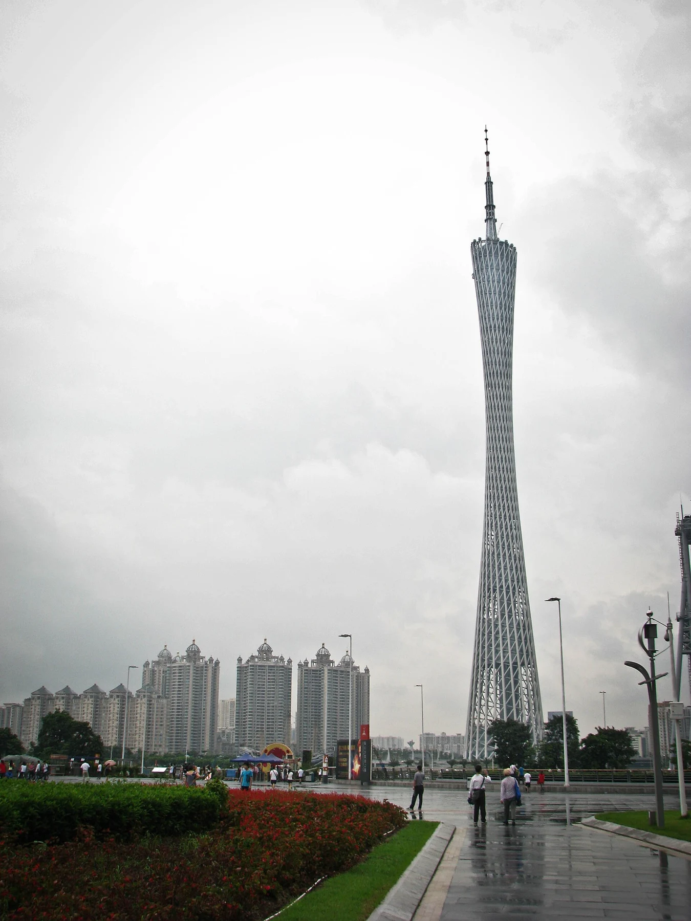 Canton Tower behind a wet approach and grey sky.