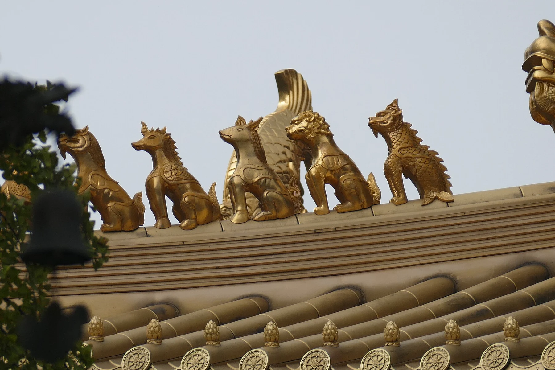 A line of sculpted roof ornaments above rounded tile ends.