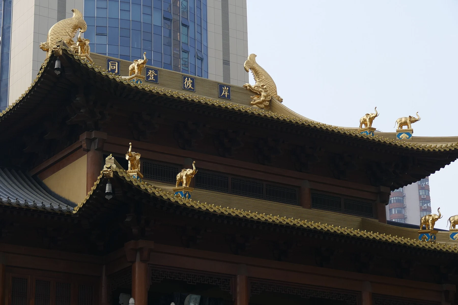 Temple roof with a dark timber underside and gilded details along the edge.