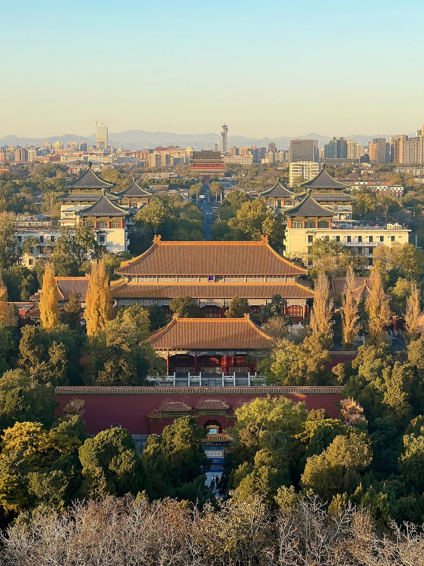 The avenue and roofscape north of Jingshan with the city skyline beyond.