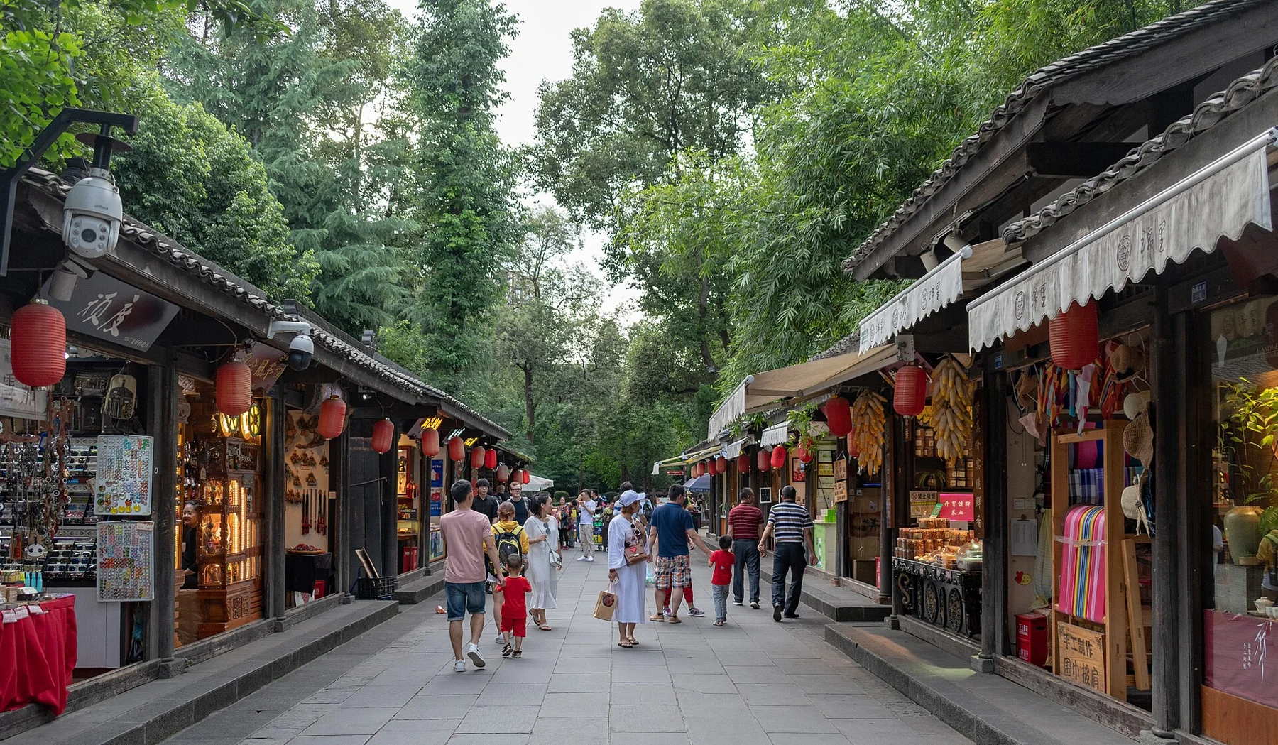 Jinli pedestrian lane with timber shops and visitors under trees