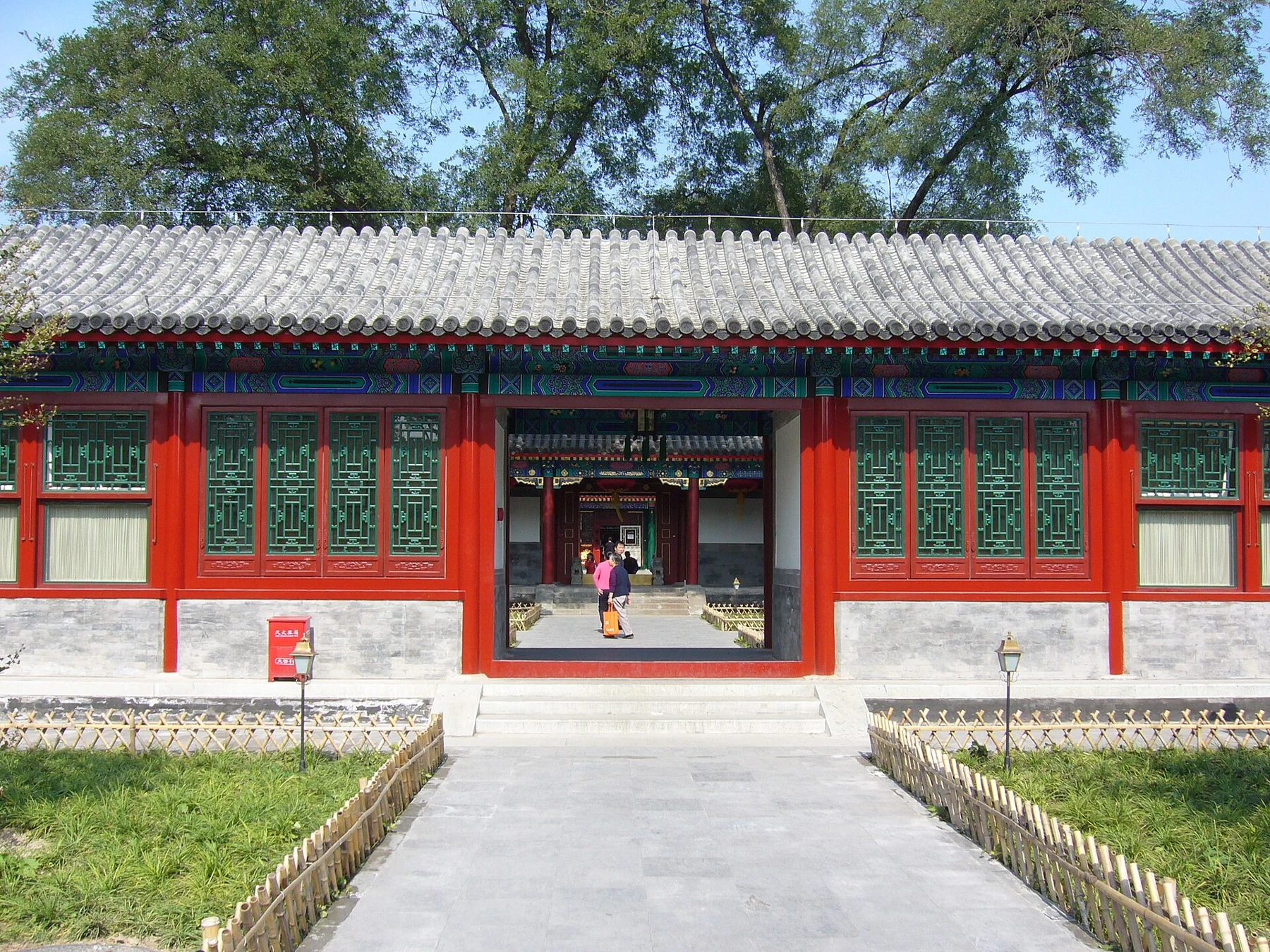 An open gateway in a red-and-grey courtyard building at the palace.