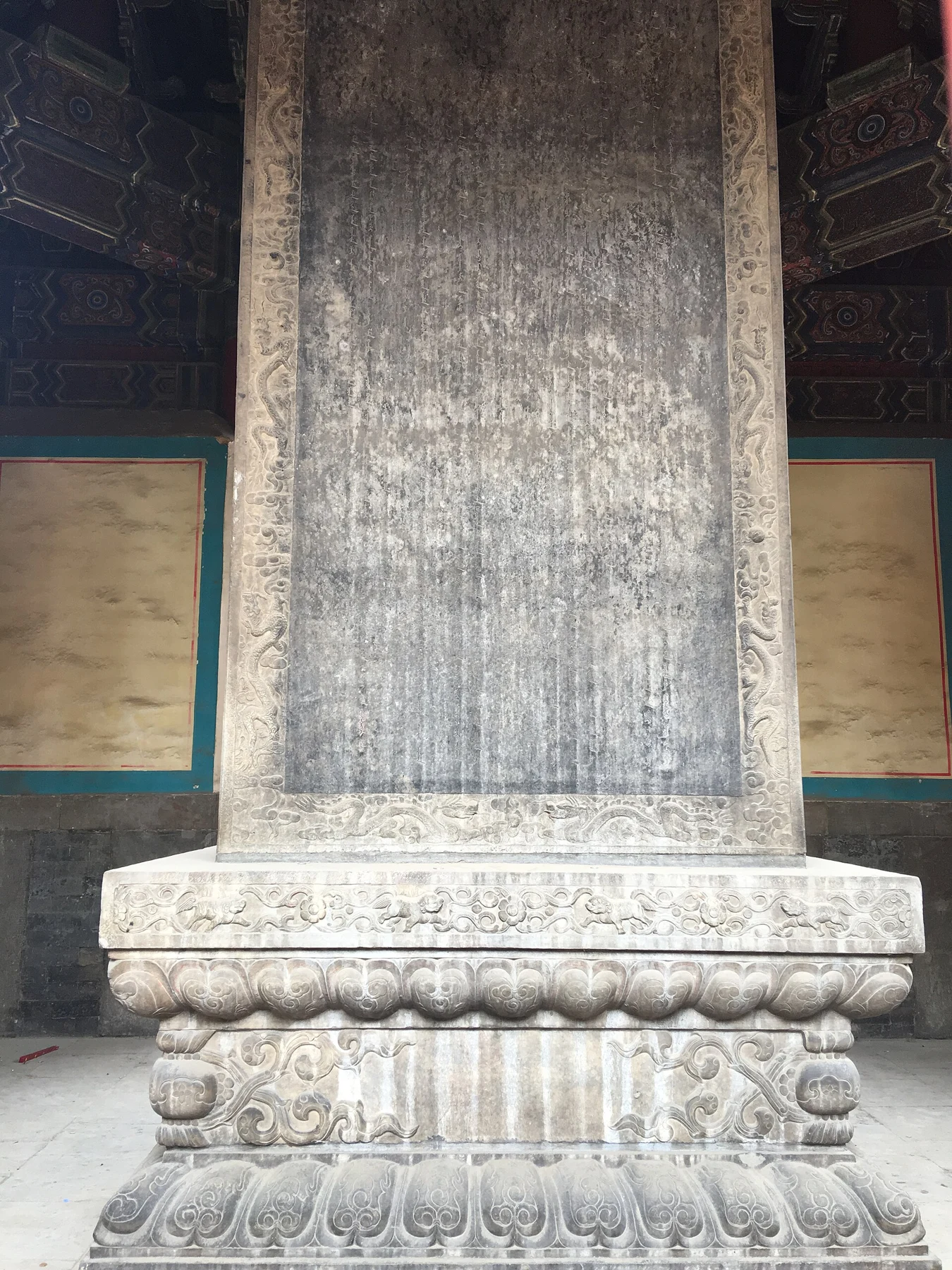 The carved text and decorated base on a face of the Lama Shuo stele.