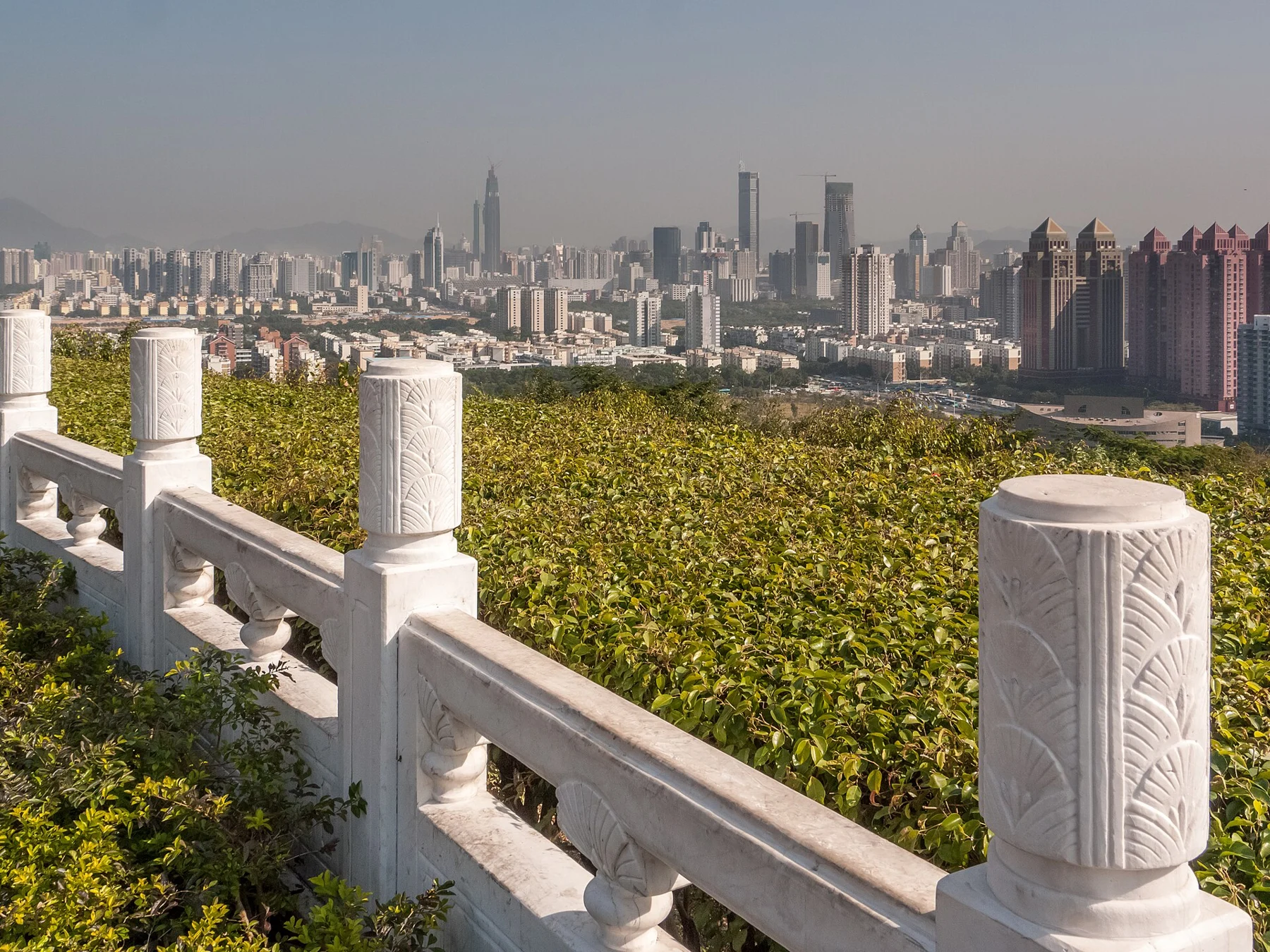 White carved railing and a distant 2010 city skyline