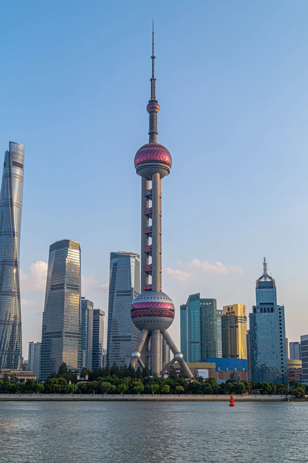 The Oriental Pearl Tower and taller financial-district towers across the Huangpu River.
