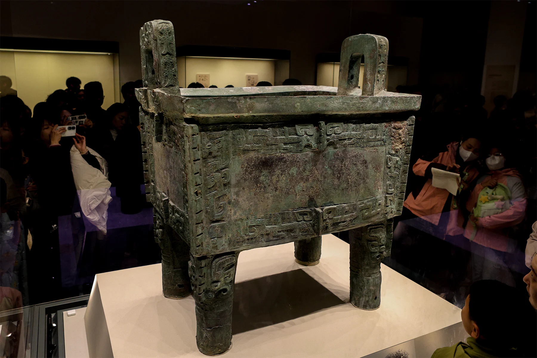The massive rectangular bronze Houmuwu cauldron, supported by four legs.
