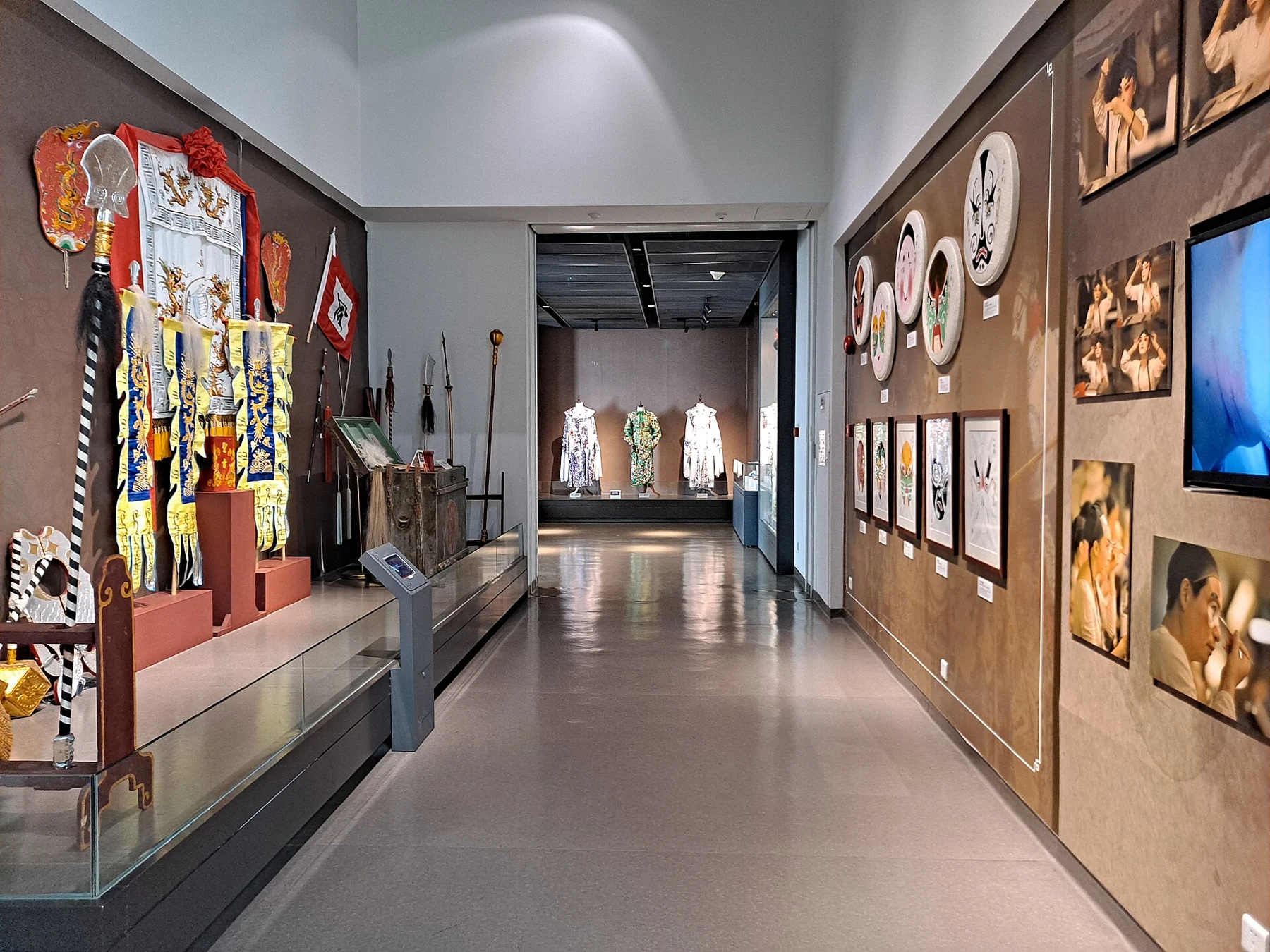 Cantonese opera museum gallery with embroidered theatrical textiles, objects and wall interpretation