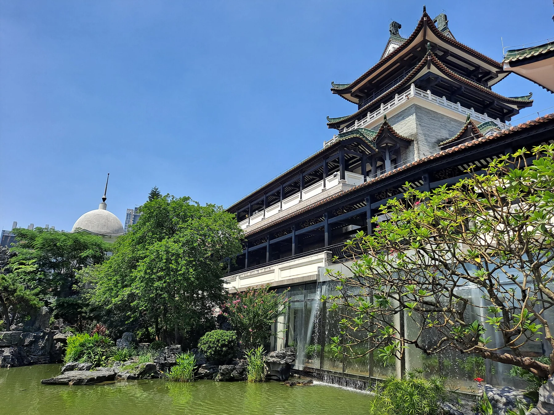 Tiered tower and long covered gallery beside the museum pond