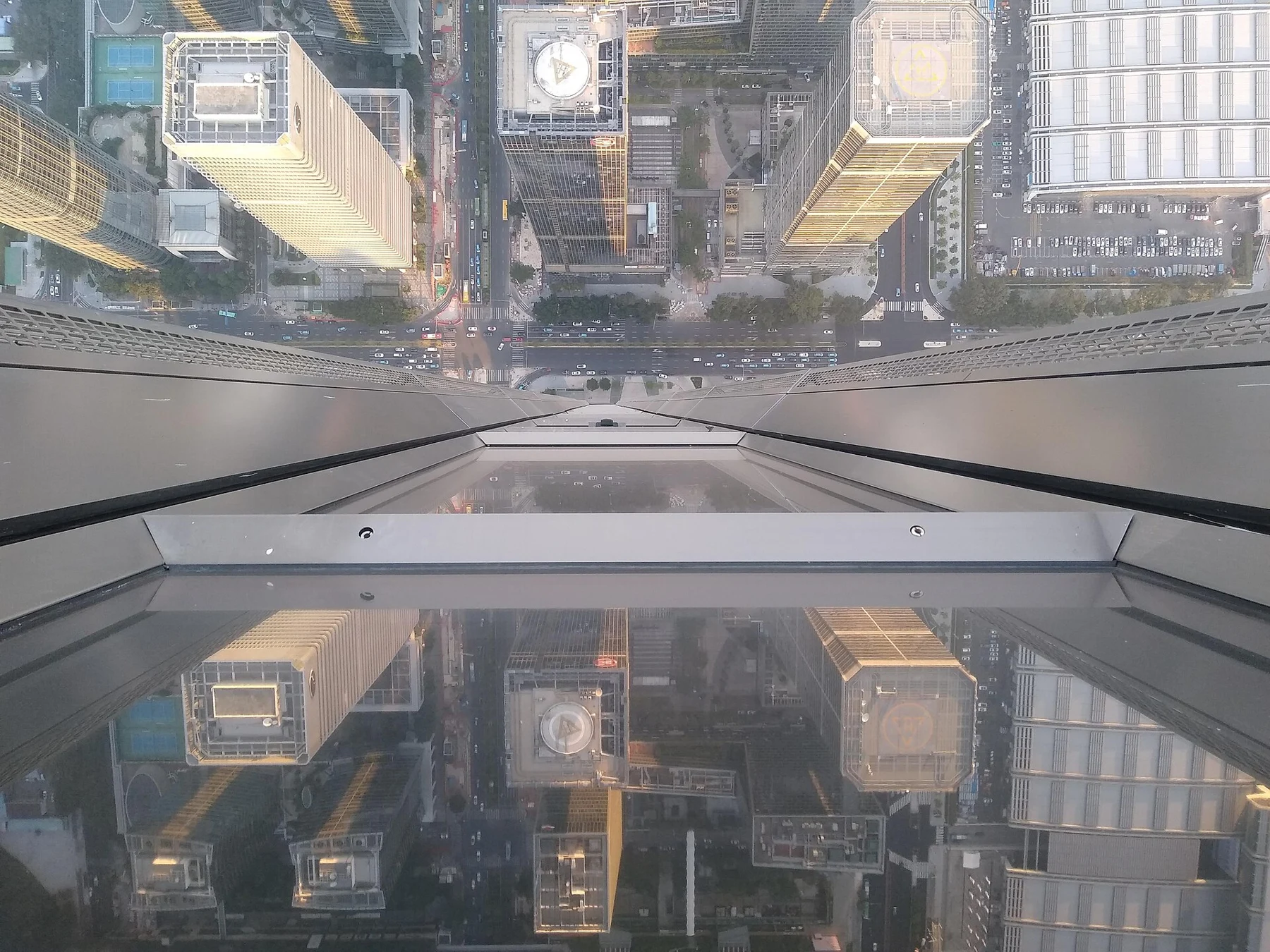 Observatory glazing and metal framing cross a downward view of the streets.