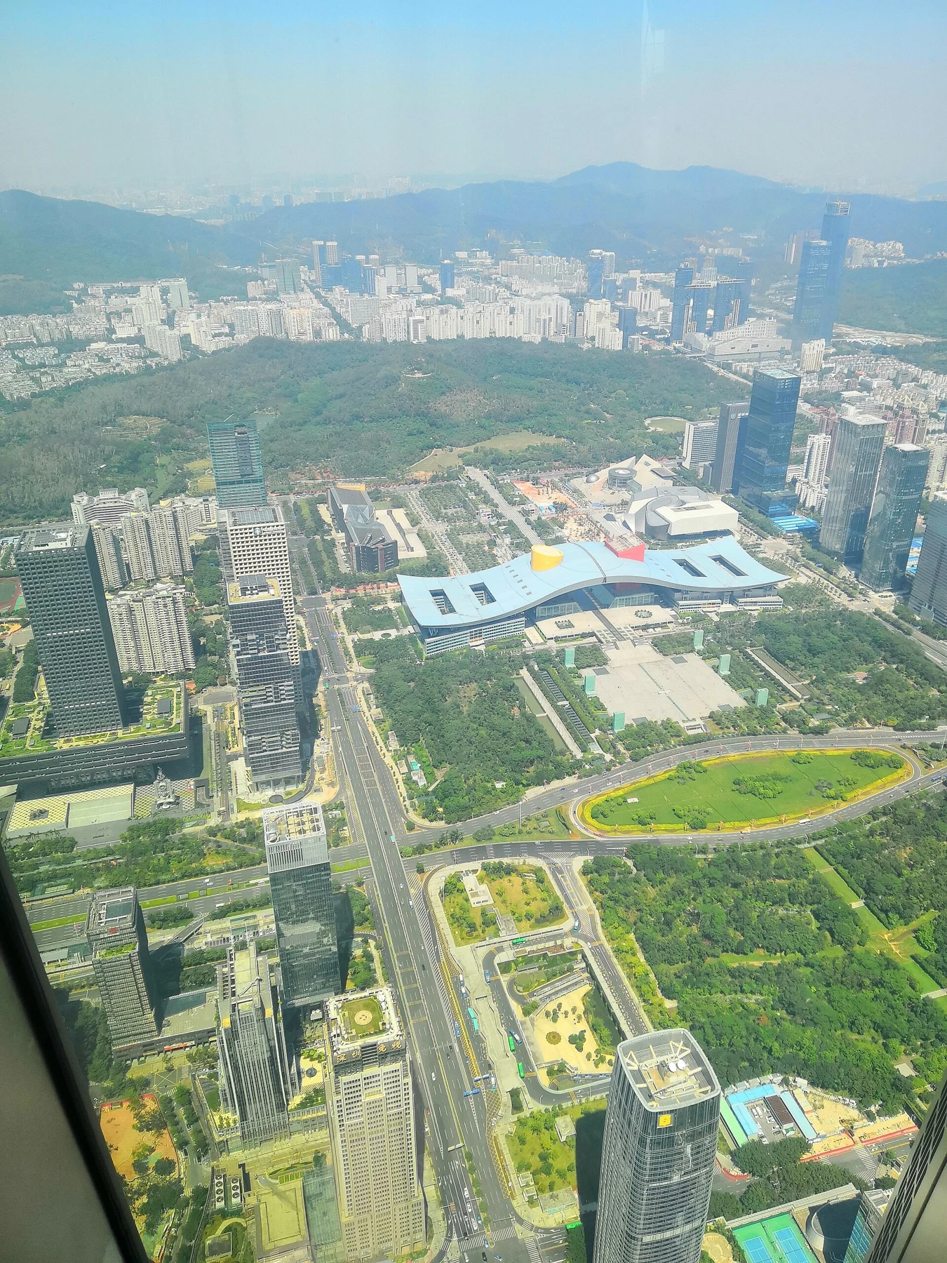 North-facing city view with Civic Center’s blue-and-white wing-like roof and lawns.