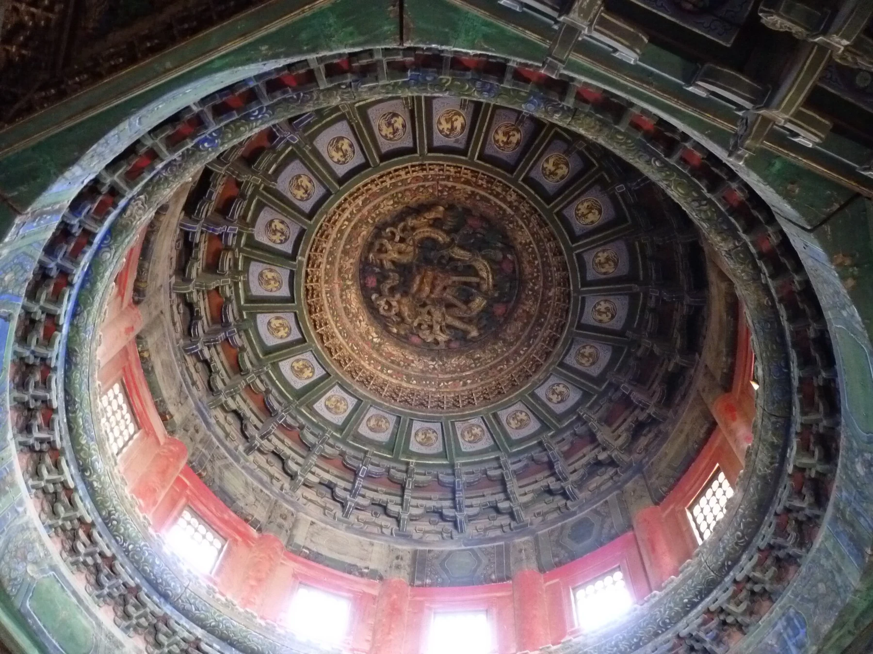 Concentric painted ceiling panels and a central dragon detail inside Qianqiu Pavilion.
