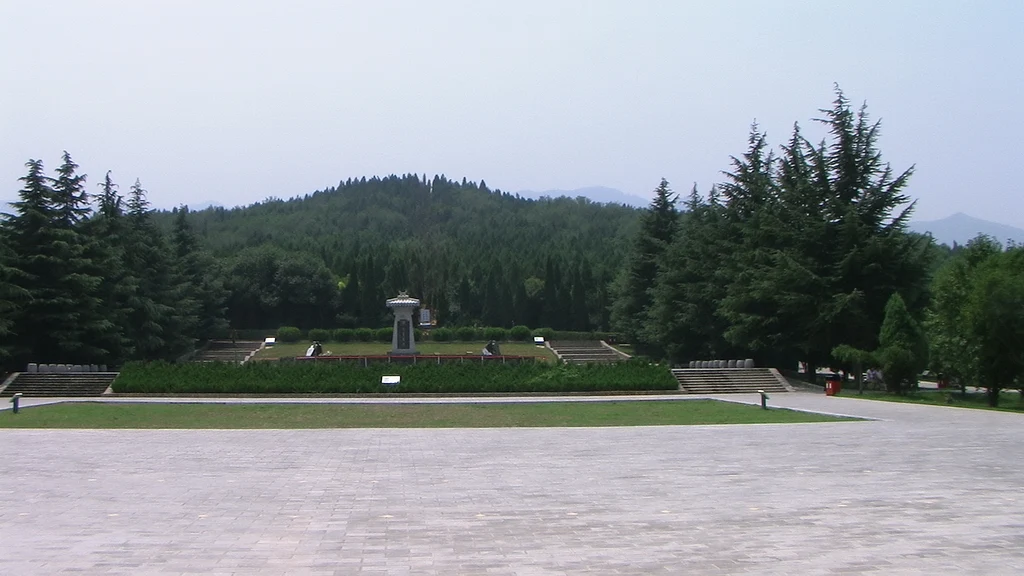 The tree-covered burial mound in an archaeological park landscape
