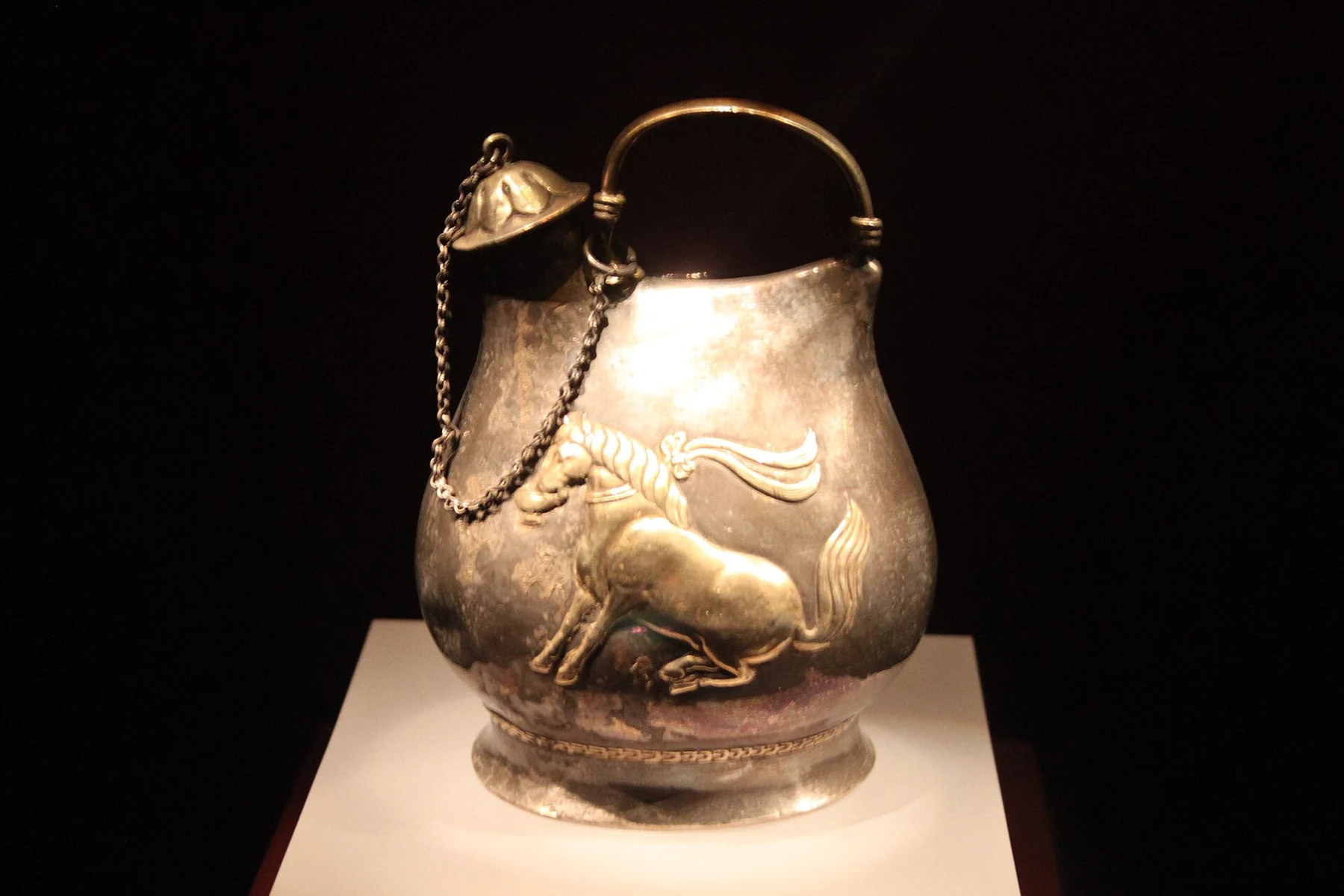 Gilded silver flask with dancing horse relief
