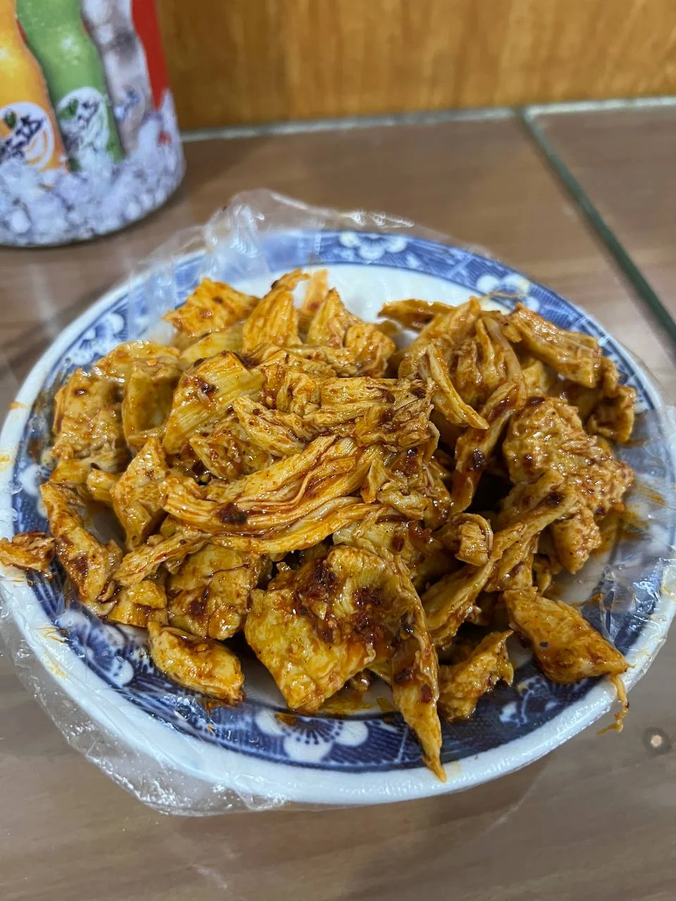 A blue-and-white bowl piled with seasoned, torn wheat-gluten pieces.