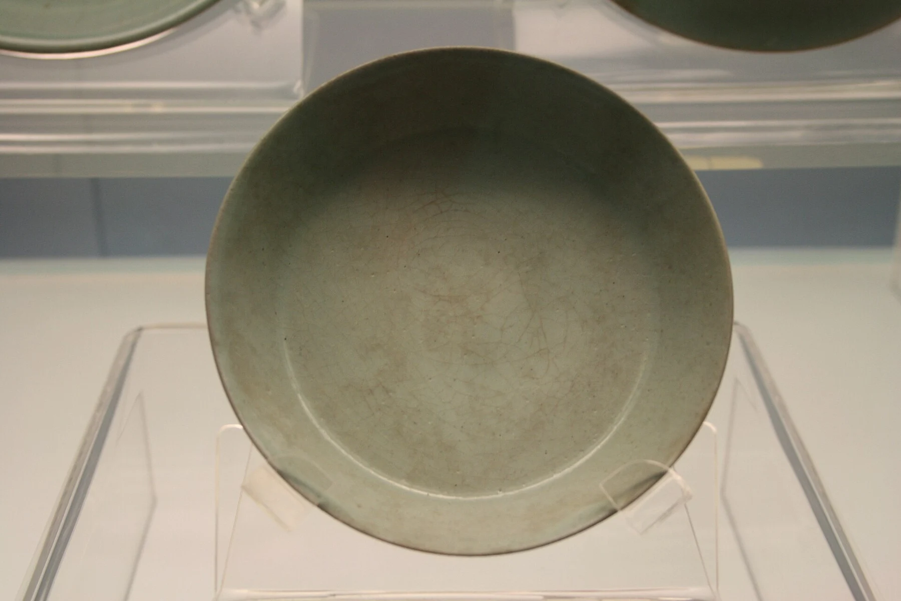 A shallow pale blue-green glazed dish viewed from above.