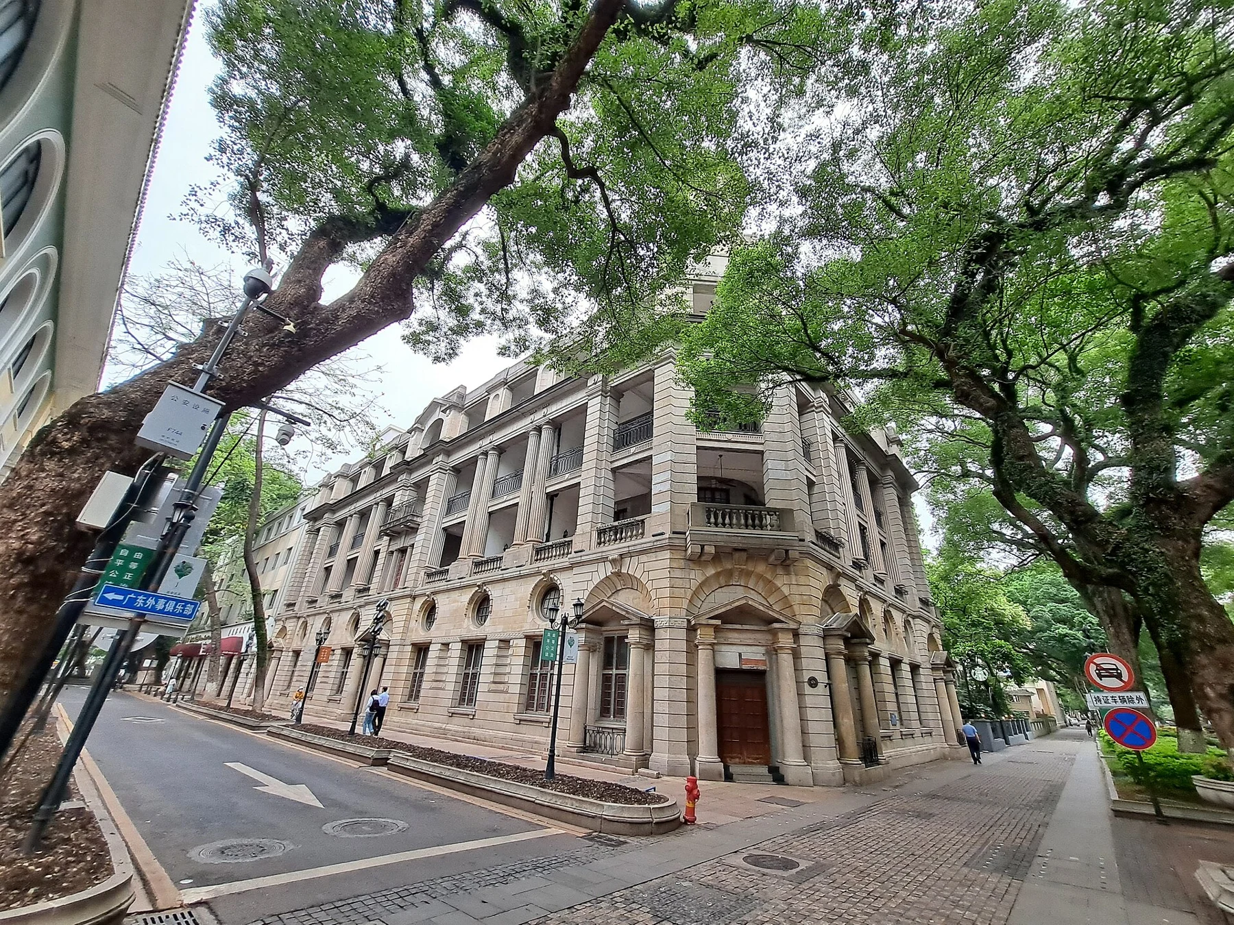 Columned corner building under trees at No. 54 Shamian Street.