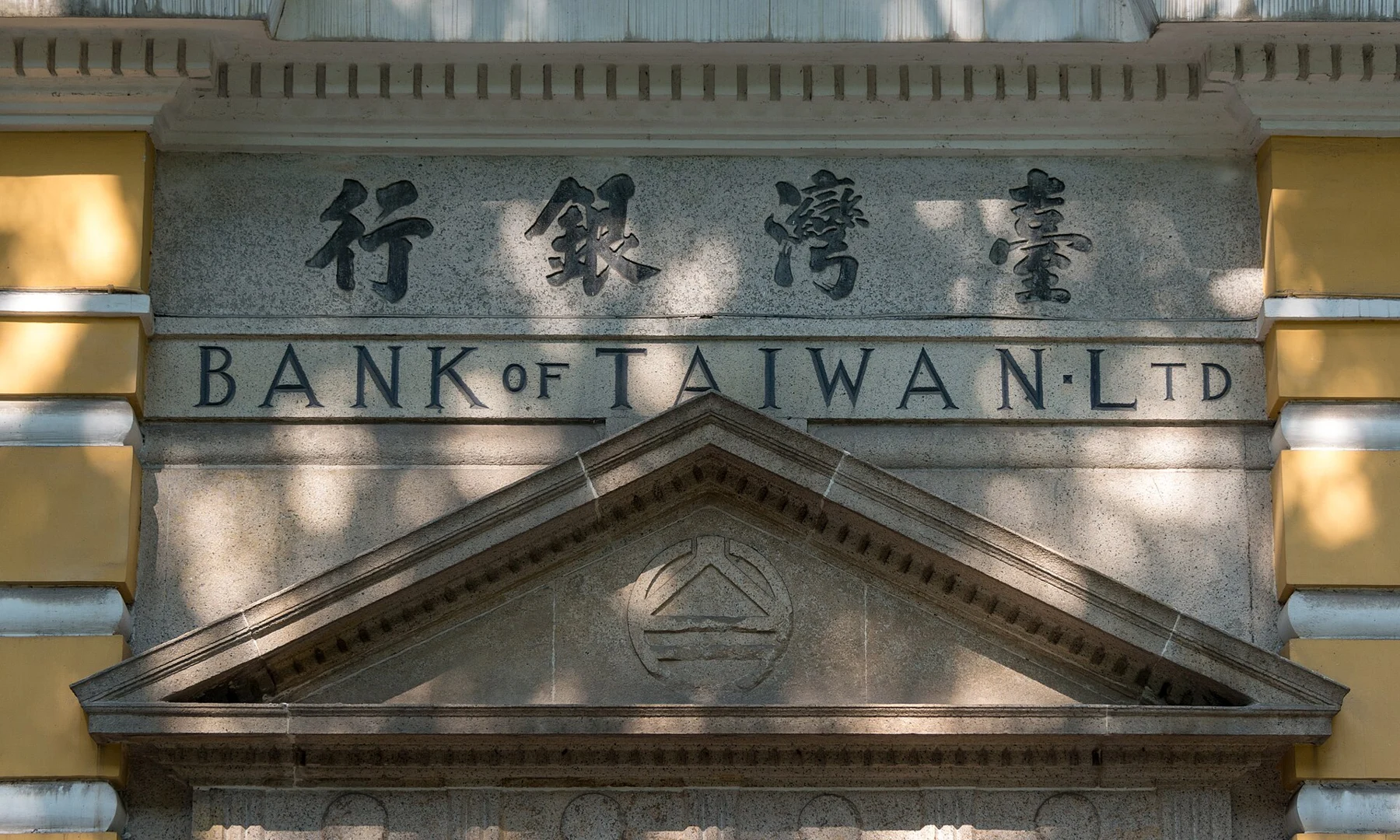 Chinese and English Bank of Taiwan lettering above a triangular doorway pediment.