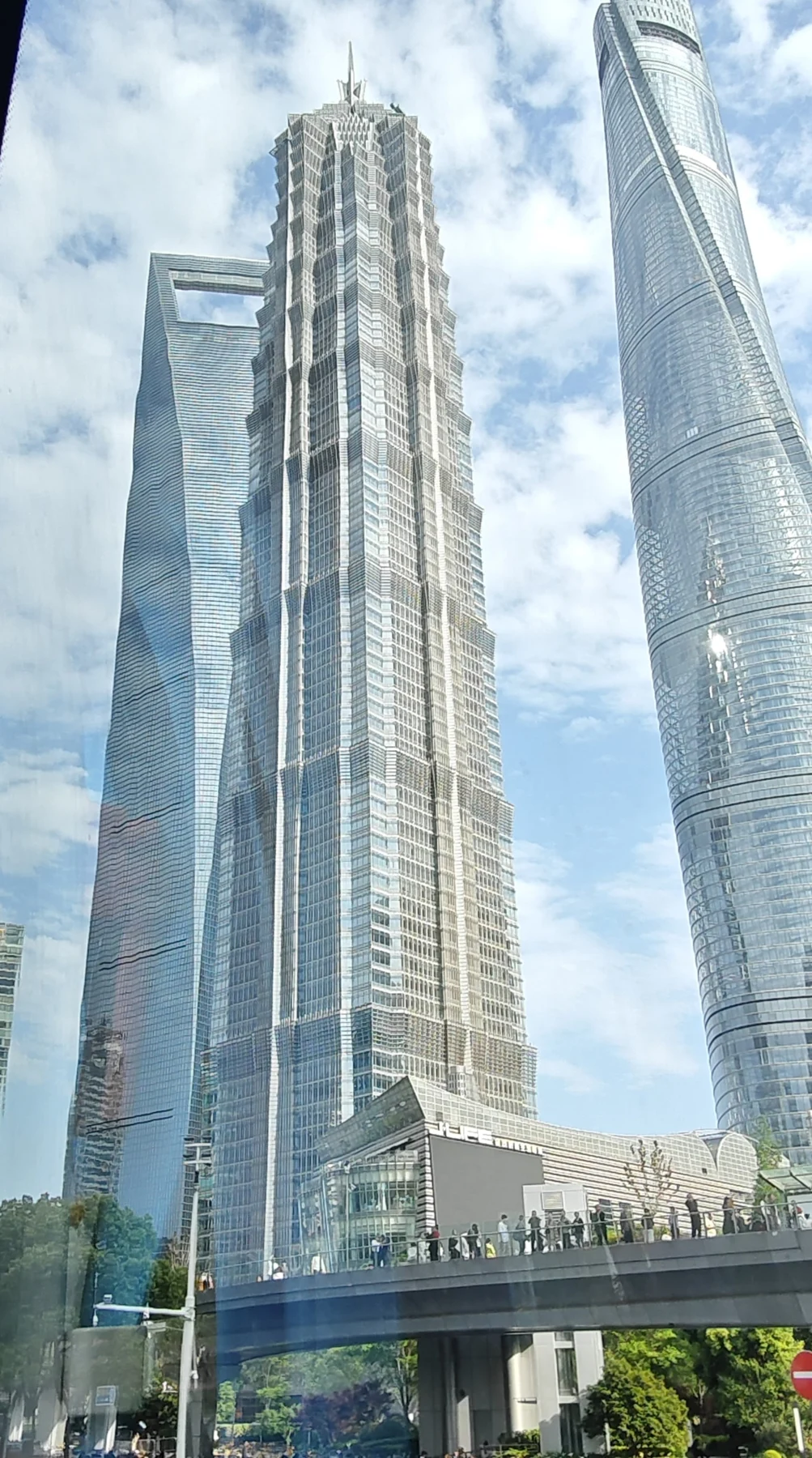 Jin Mao in front of the World Financial Center and Shanghai Tower, seen from the street.