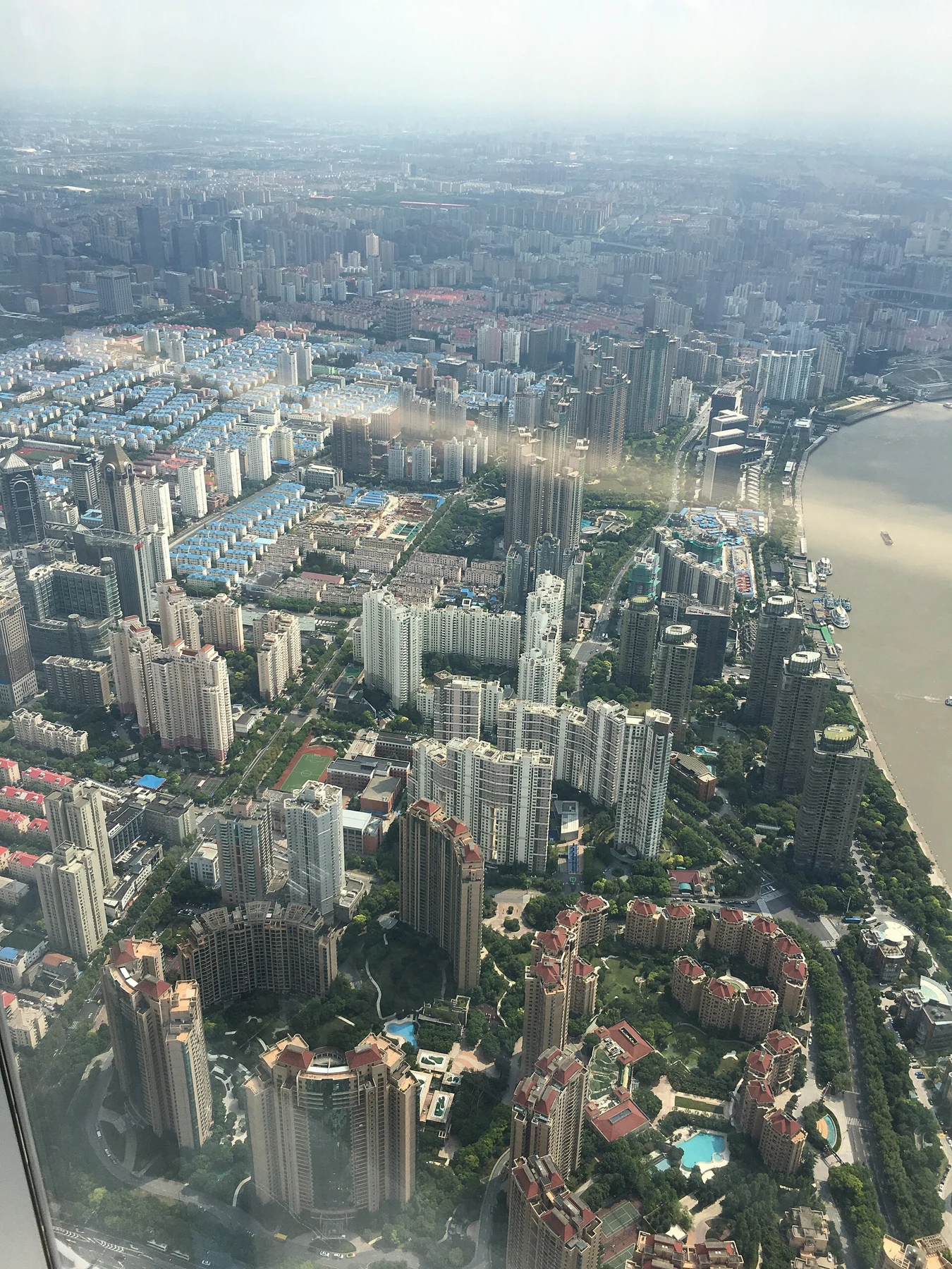 Residential blocks, roads, green spaces and river bends in the wider city.