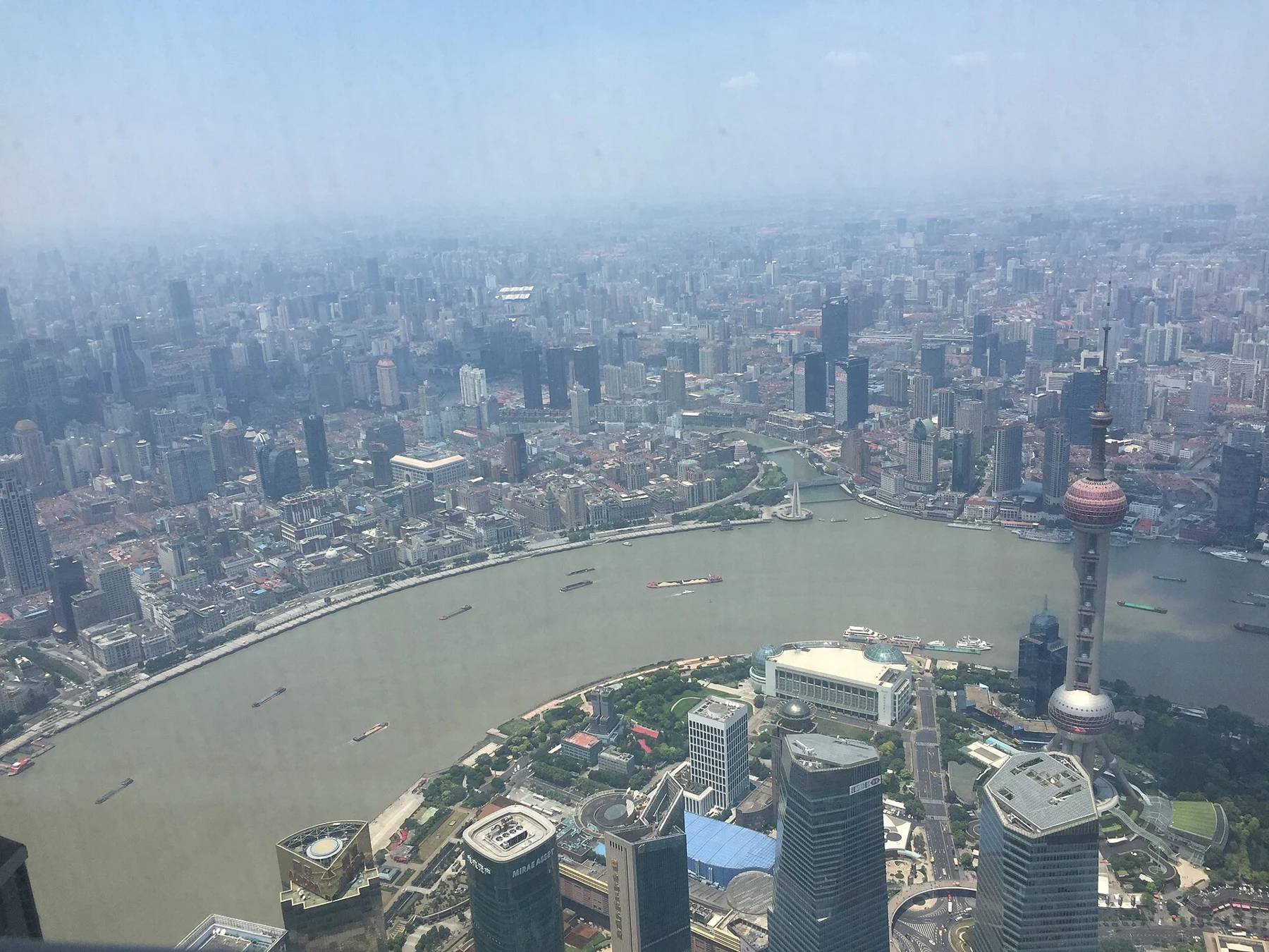 River and waterfront city from above with the Oriental Pearl Tower at right.