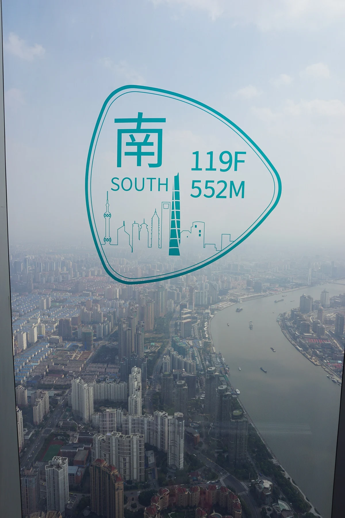 An old south-facing 119F 552M window sign above the Huangpu River view.