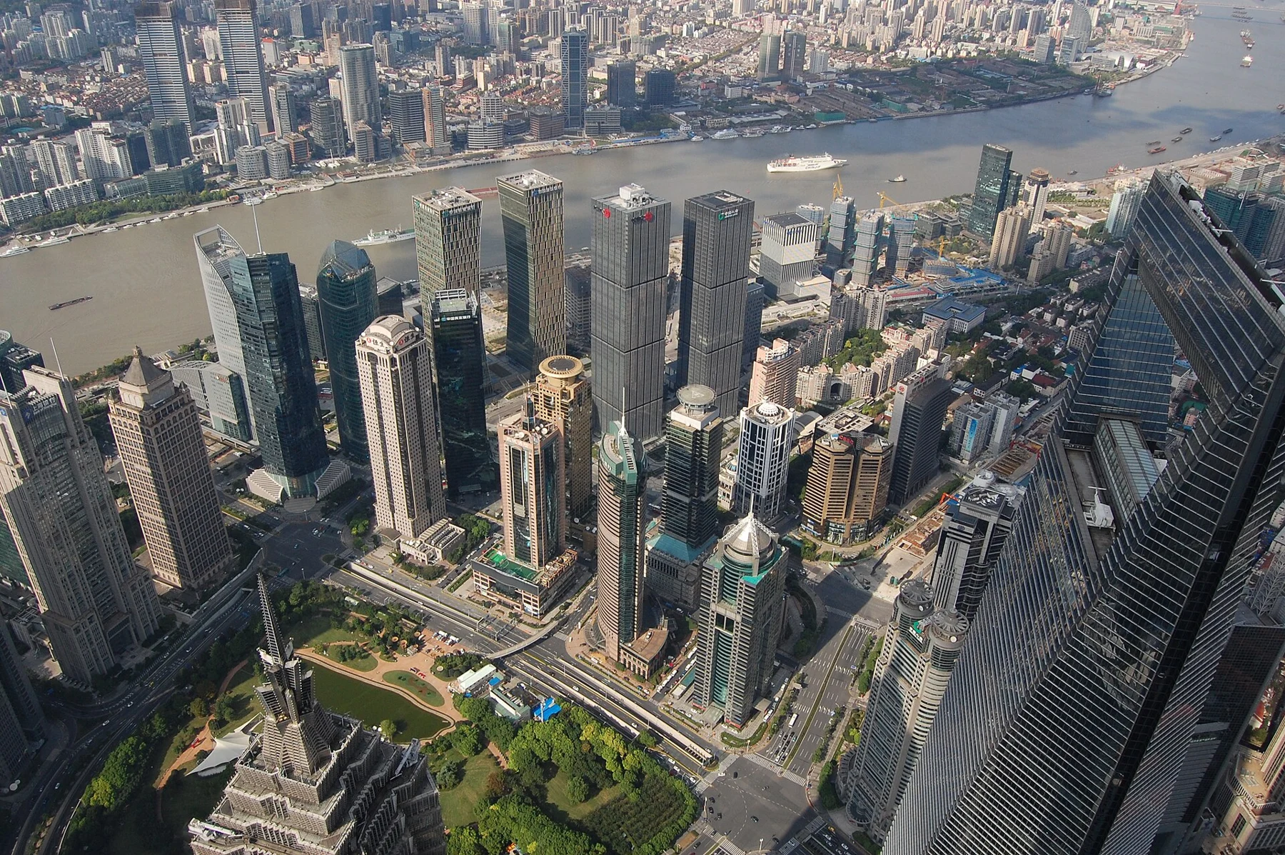 Close city view with Jin Mao and the World Financial Center below, and the Huangpu in the background.