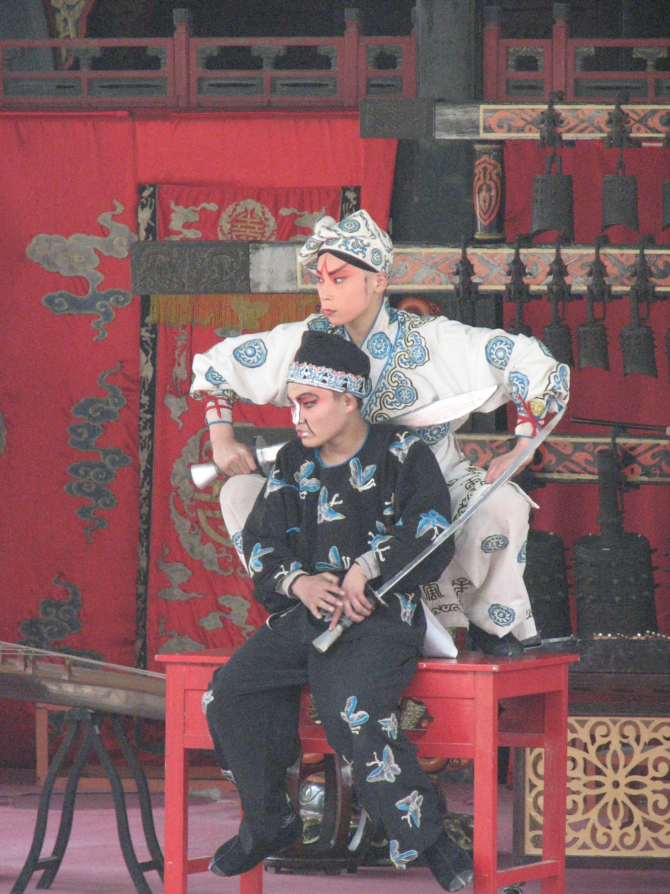 Two costumed performers on the Summer Palace stage in a historical photograph.