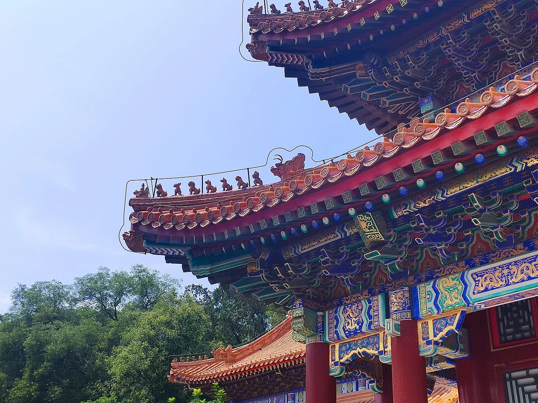 The layered roof eaves and decorative glazed roof details of a traditional building.