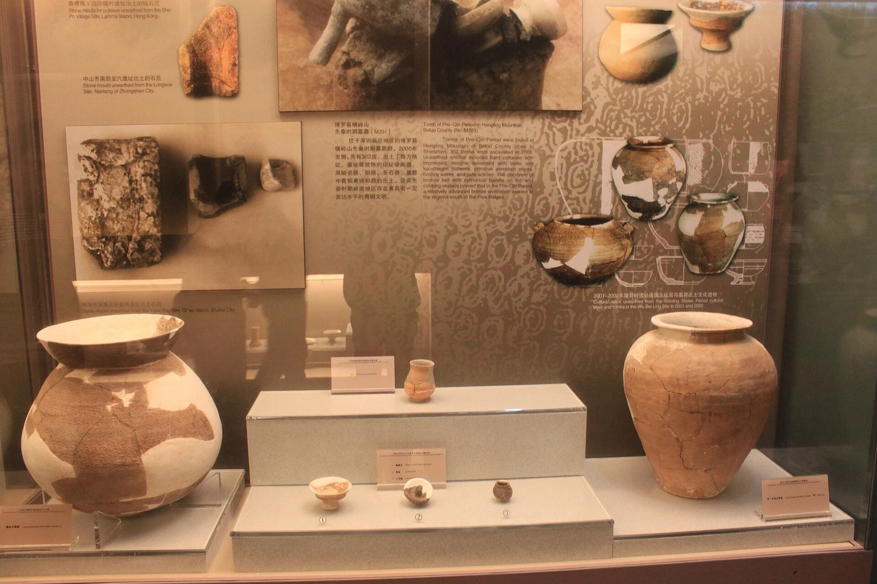 Repaired pottery vessels, bowls and panels showing archaeological contexts from the wider region