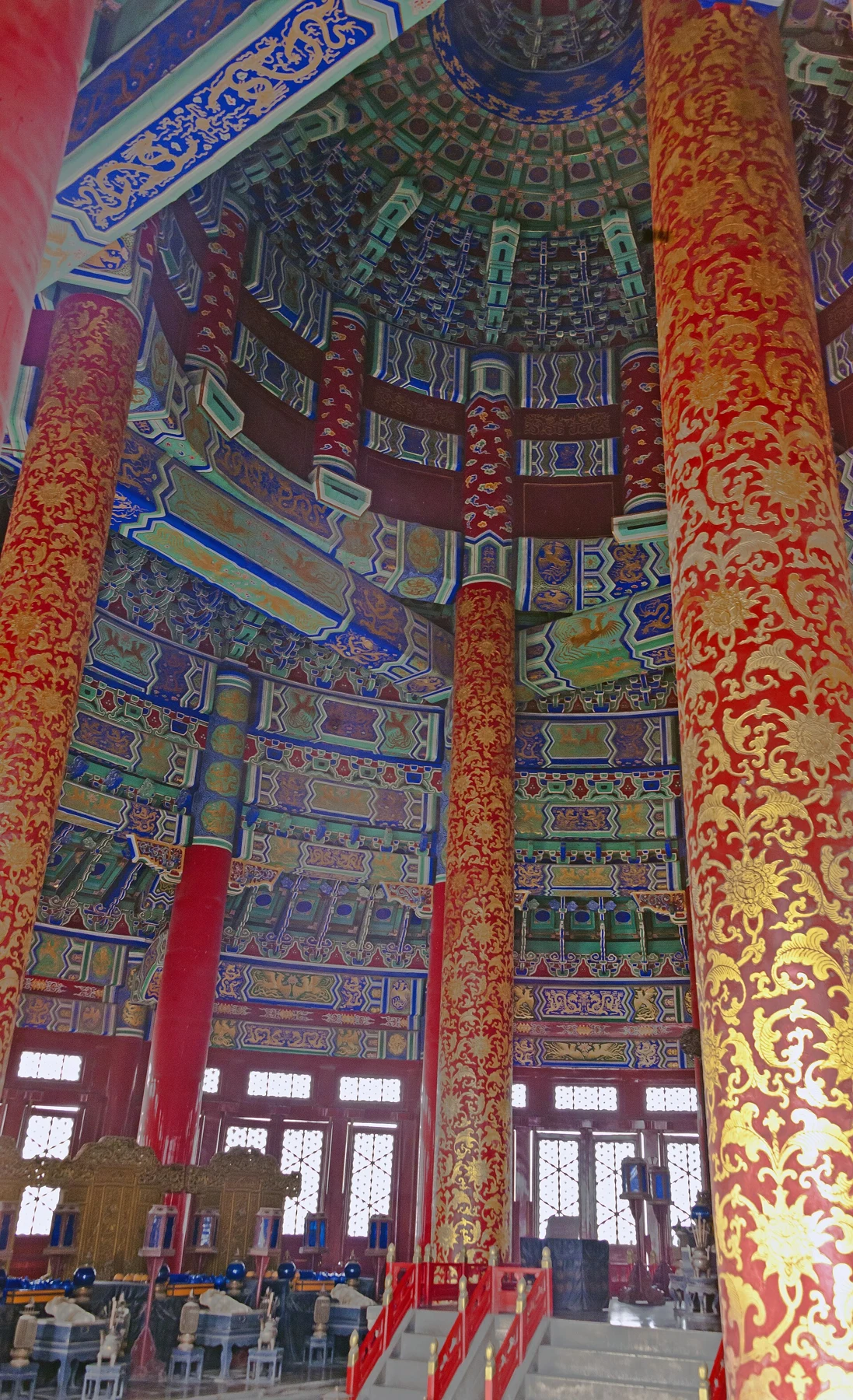 Painted red-and-gold columns and a richly patterned ceiling inside the Hall of Prayer for Good Harvests.