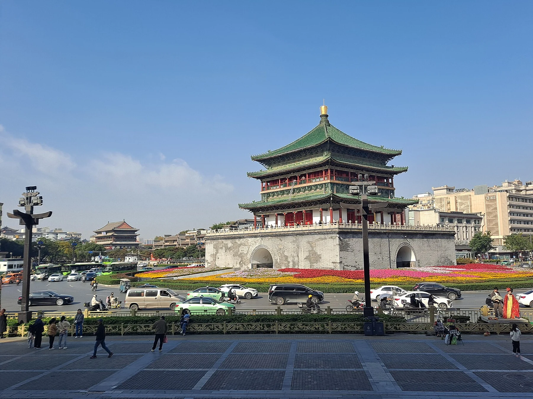 Bell Tower seen across traffic from a pedestrian edge.