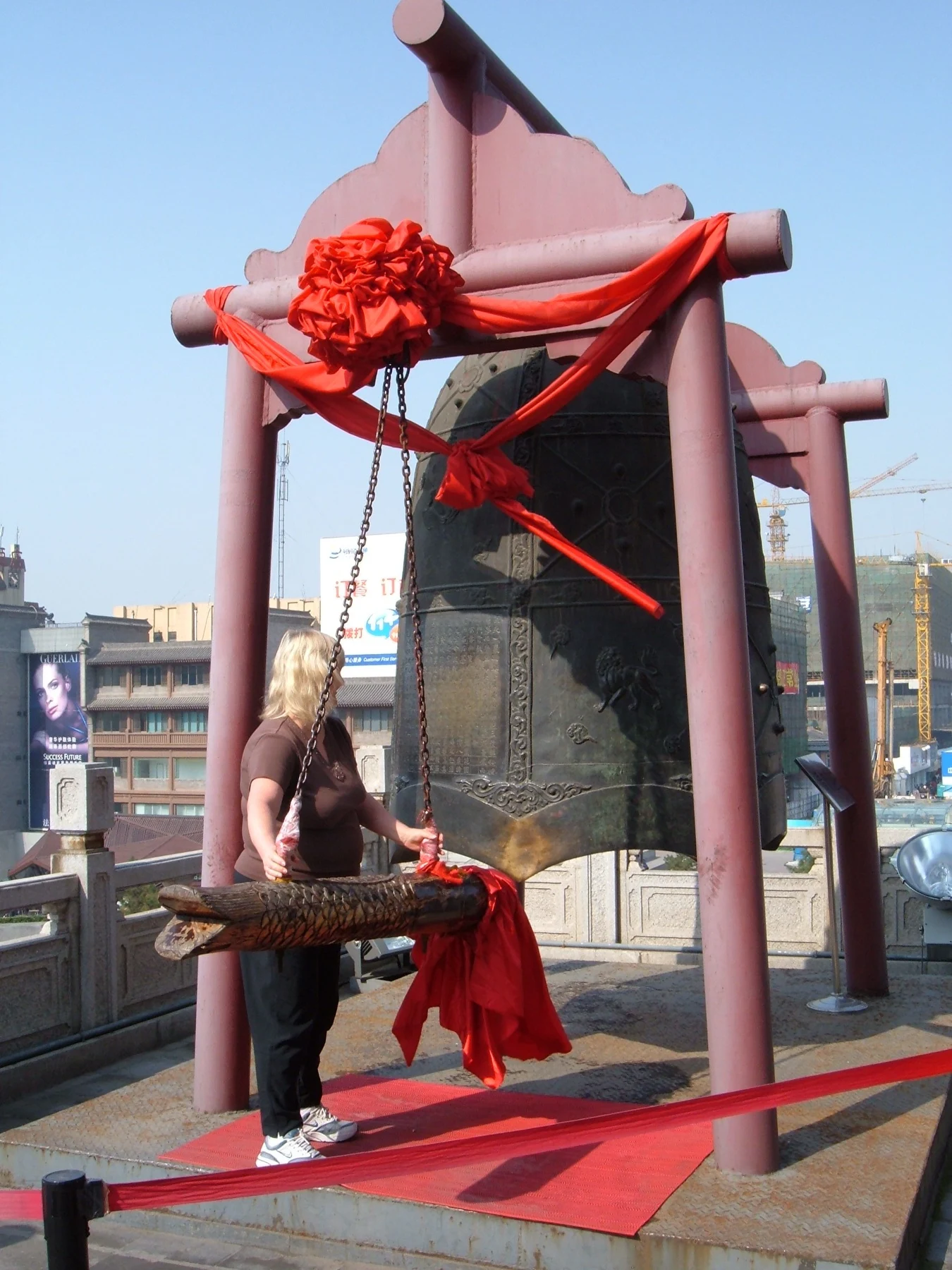 A suspended bronze bell replica and its striking beam on the Bell Tower platform.