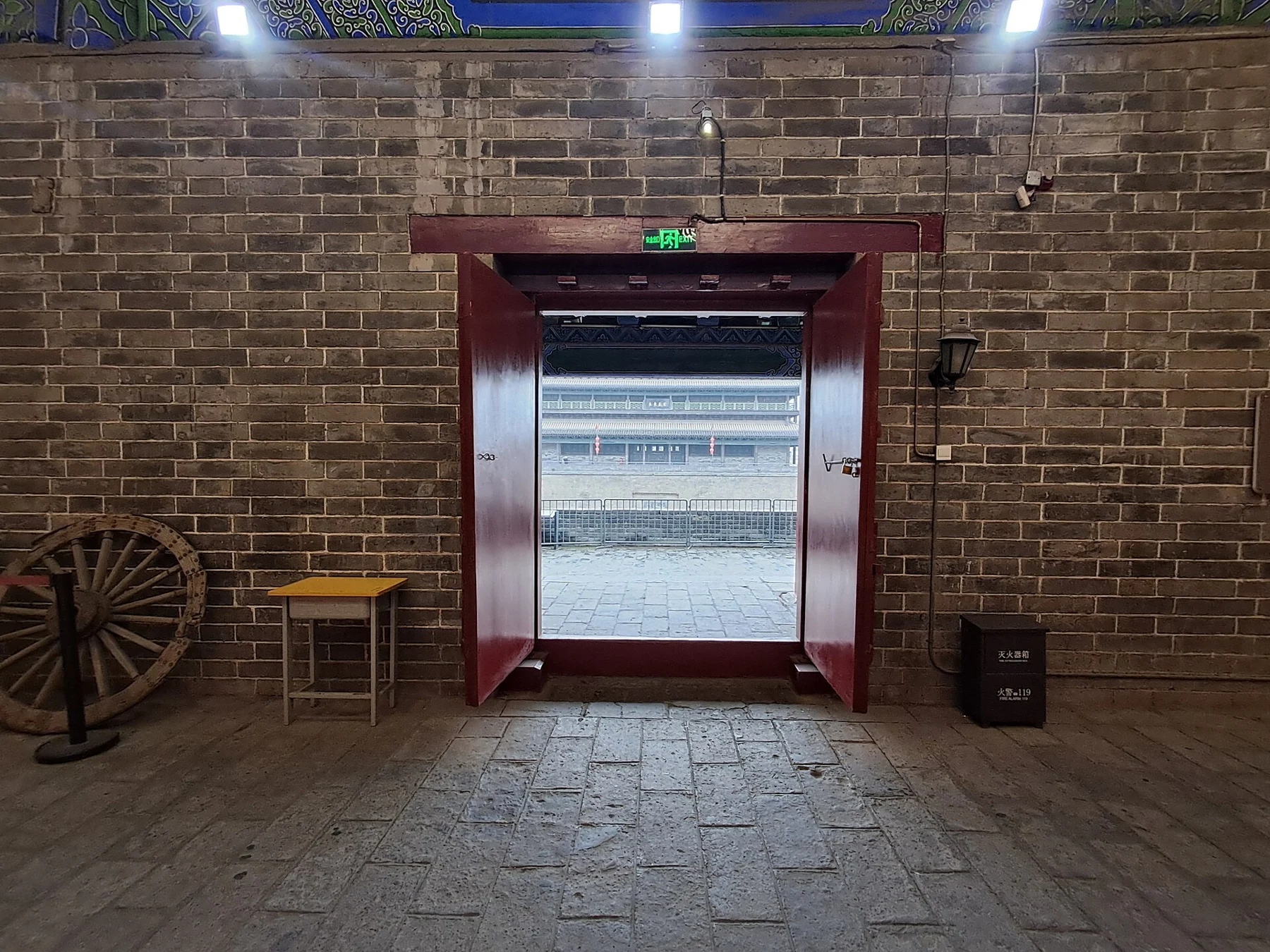 Interior of a city-wall building with a doorway and small display
