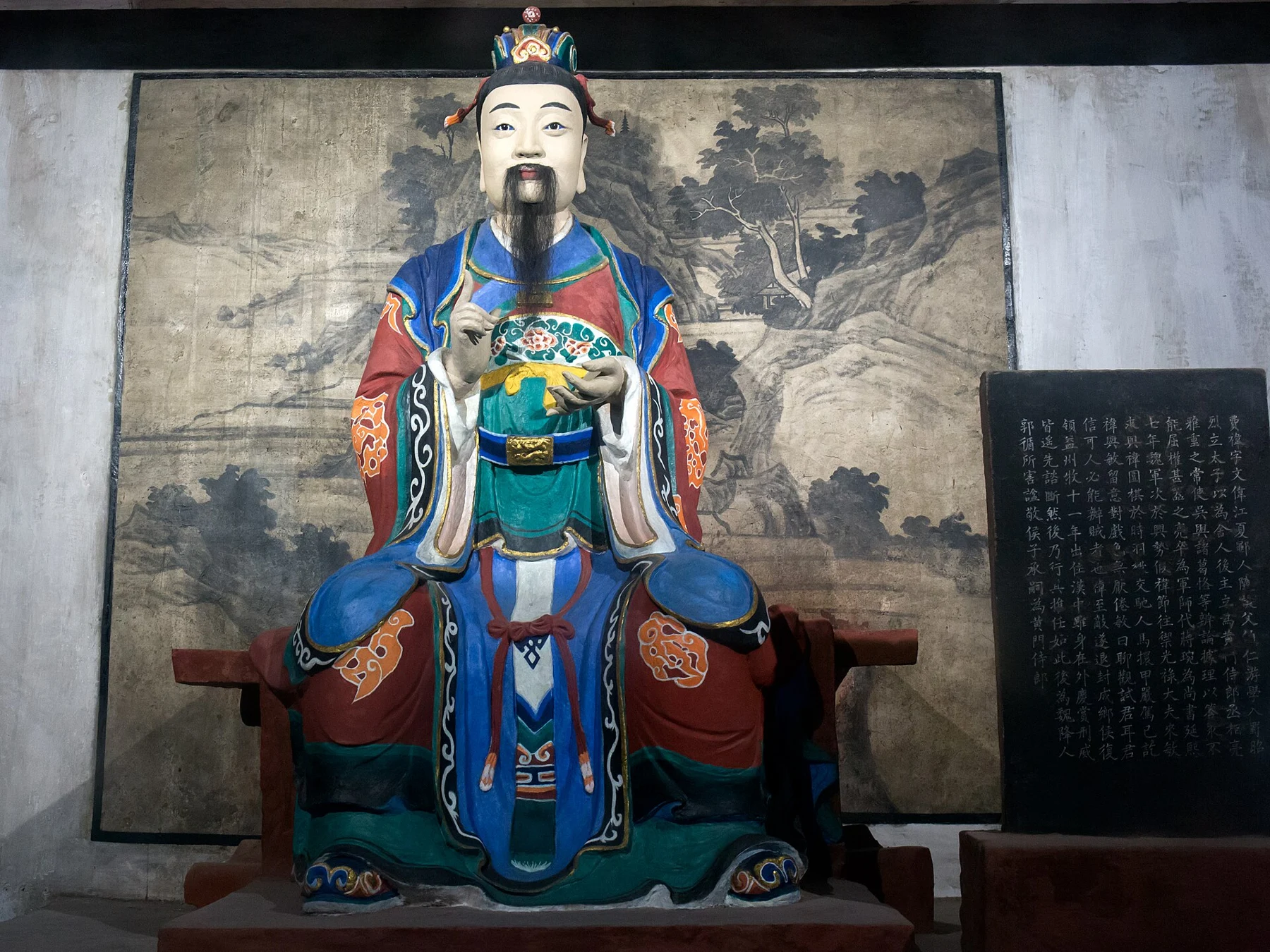 Painted seated Fei Yi figure with a written identification panel