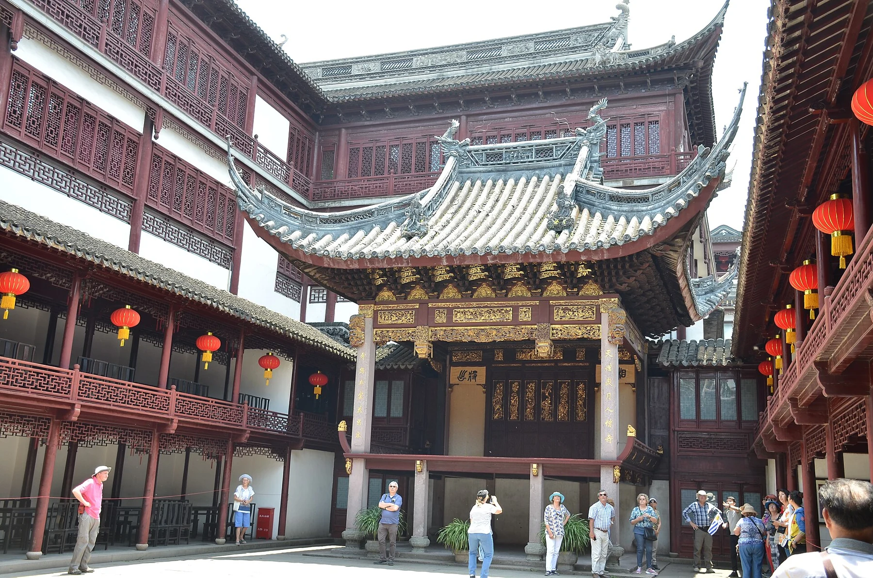 A decorated garden theatre stage with surrounding viewing architecture and an open forecourt.